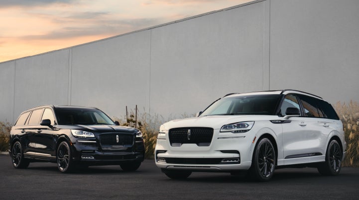 Two Lincoln Aviator® SUVs are shown with the available Jet Appearance Package | Rydell Lincoln in Independence IA
